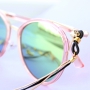 Summer proof: sunglasses cords with golden details and minimalist earrings