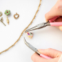 Create a funky charm necklace with metal charms with enamel